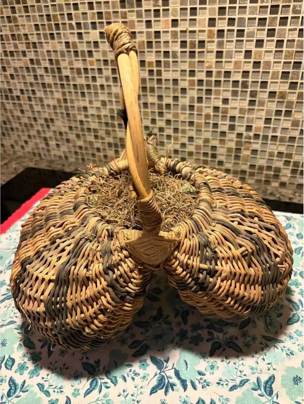 This is a vintage hand-woven double buttocks wicker harvest basket.